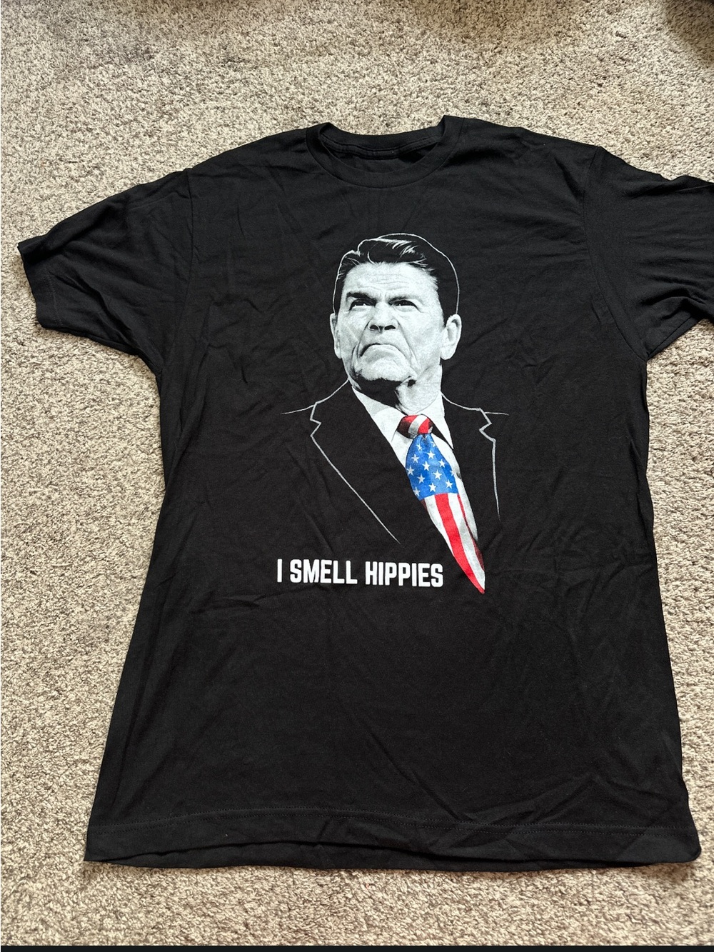 Black Graphic Tee with Patriotic Tie Print Ronald Regan I smell hippies